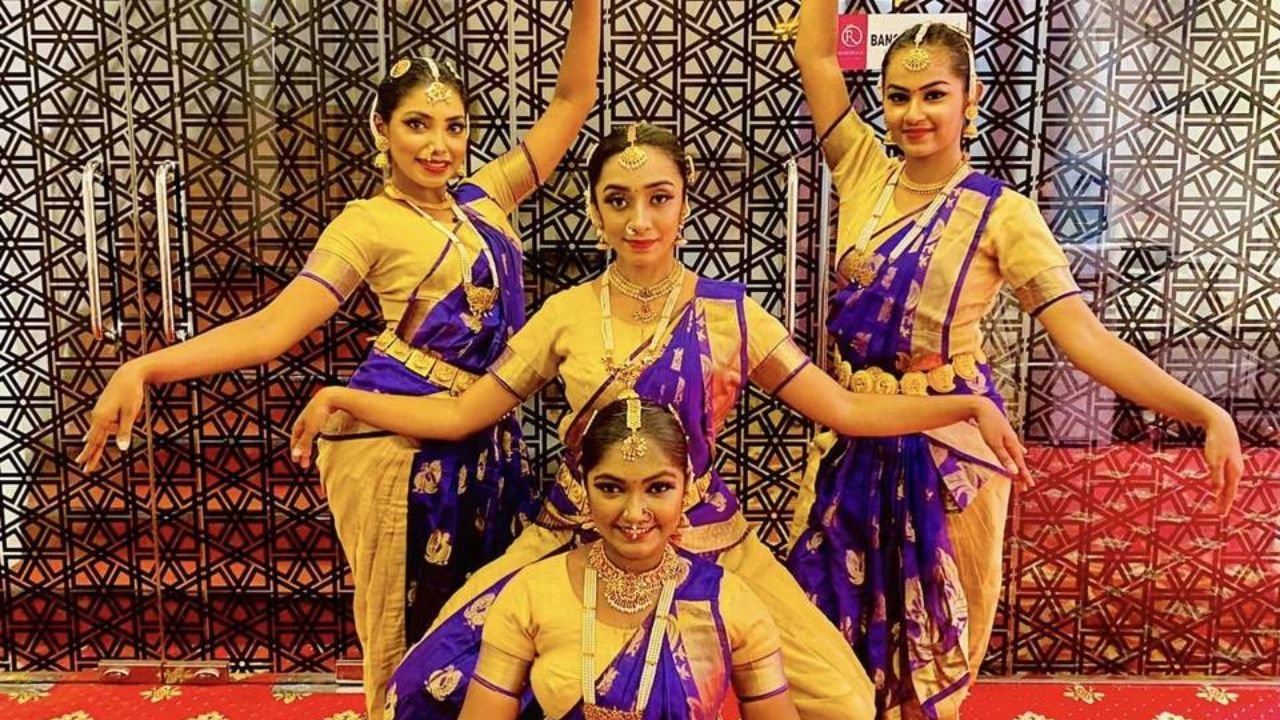Dance troupe in coordinated costumes at a Navratri show