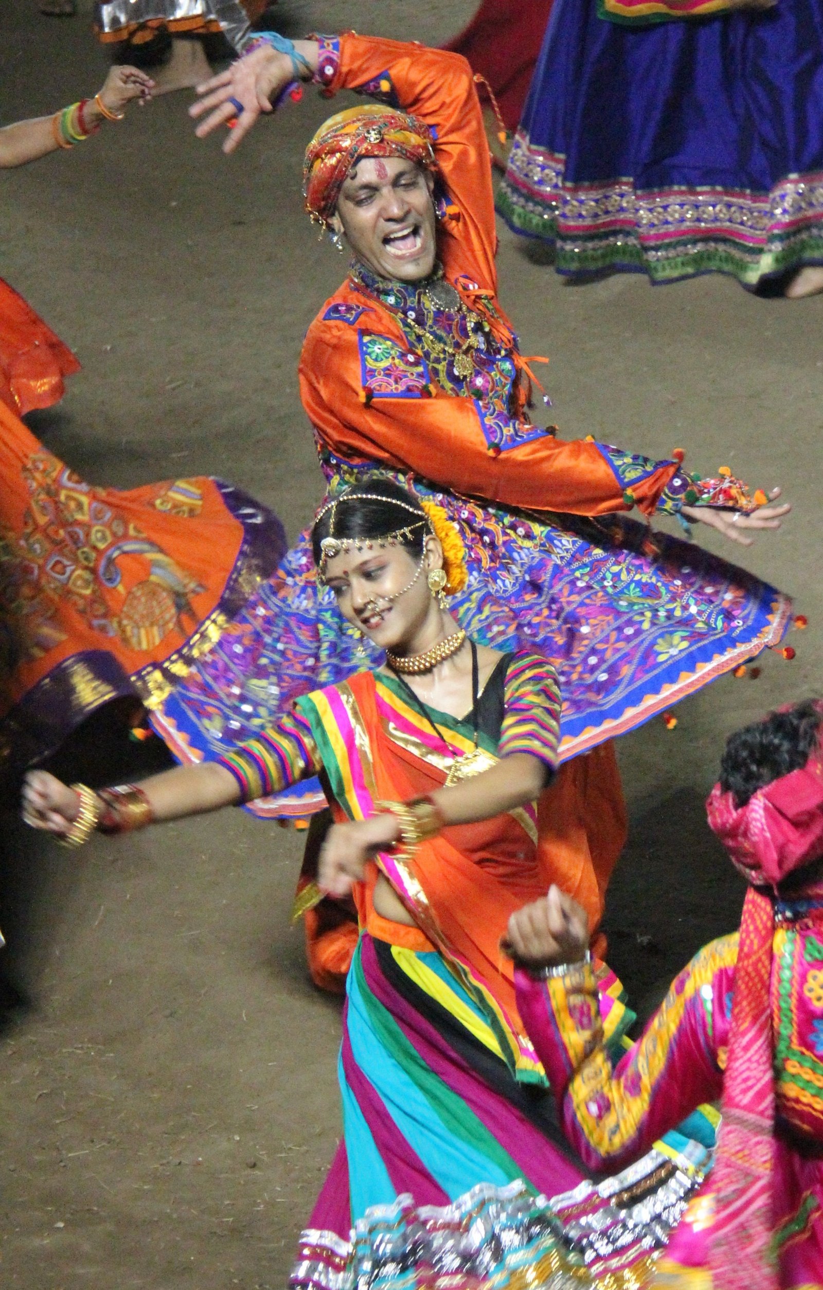 Dancers in traditional Navratri attire performing garba on stage