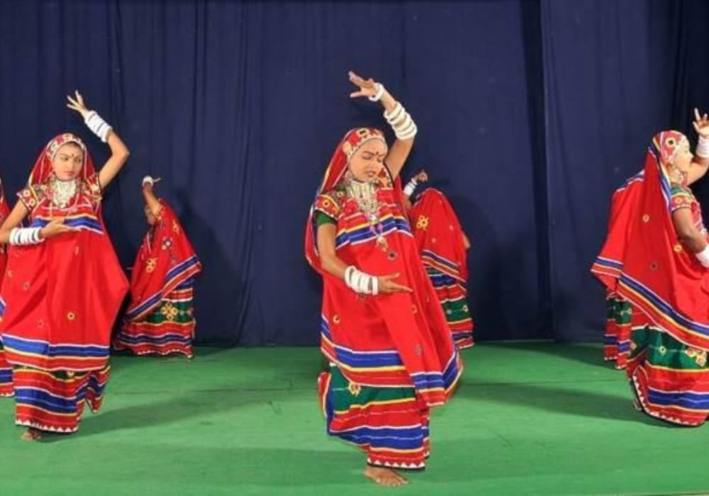 Banjara singers in traditional Lamani attire performing authentic Lokgeet with folk instruments at a cultural event